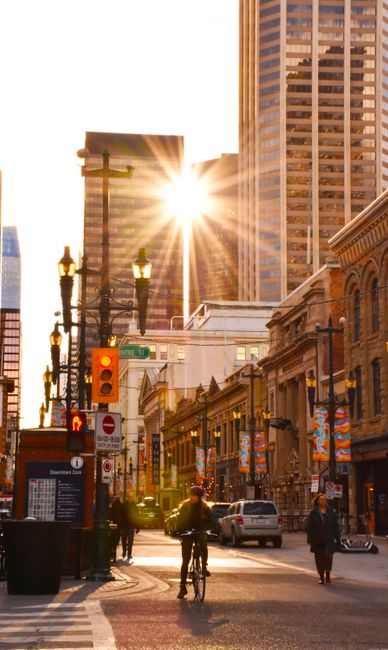 Cyclist on a downtown street at sunset
