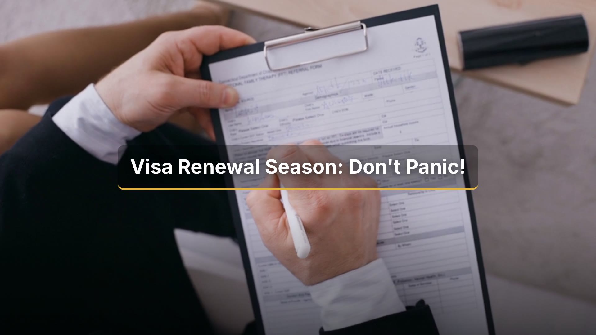 Person completing a visa renewal form on a clipboard