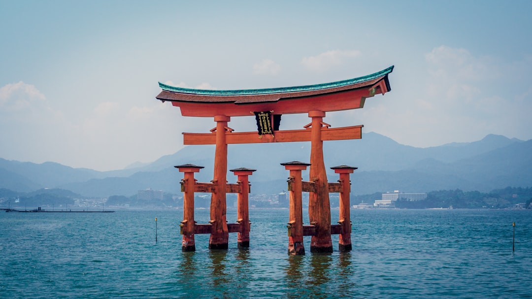Itsukushima torii gate standing in water in Japan