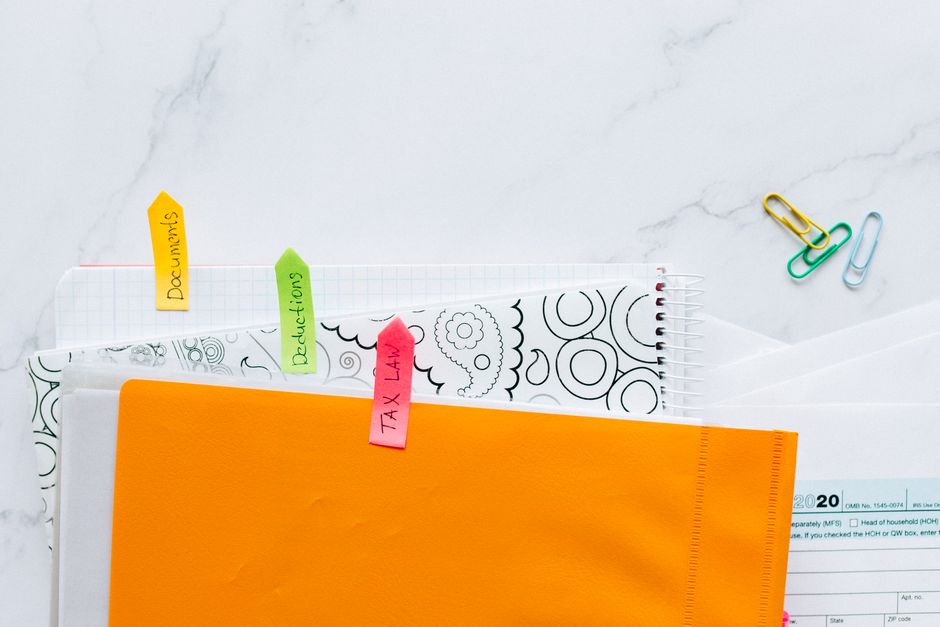 Documents and a labelled folder arranged on a desk